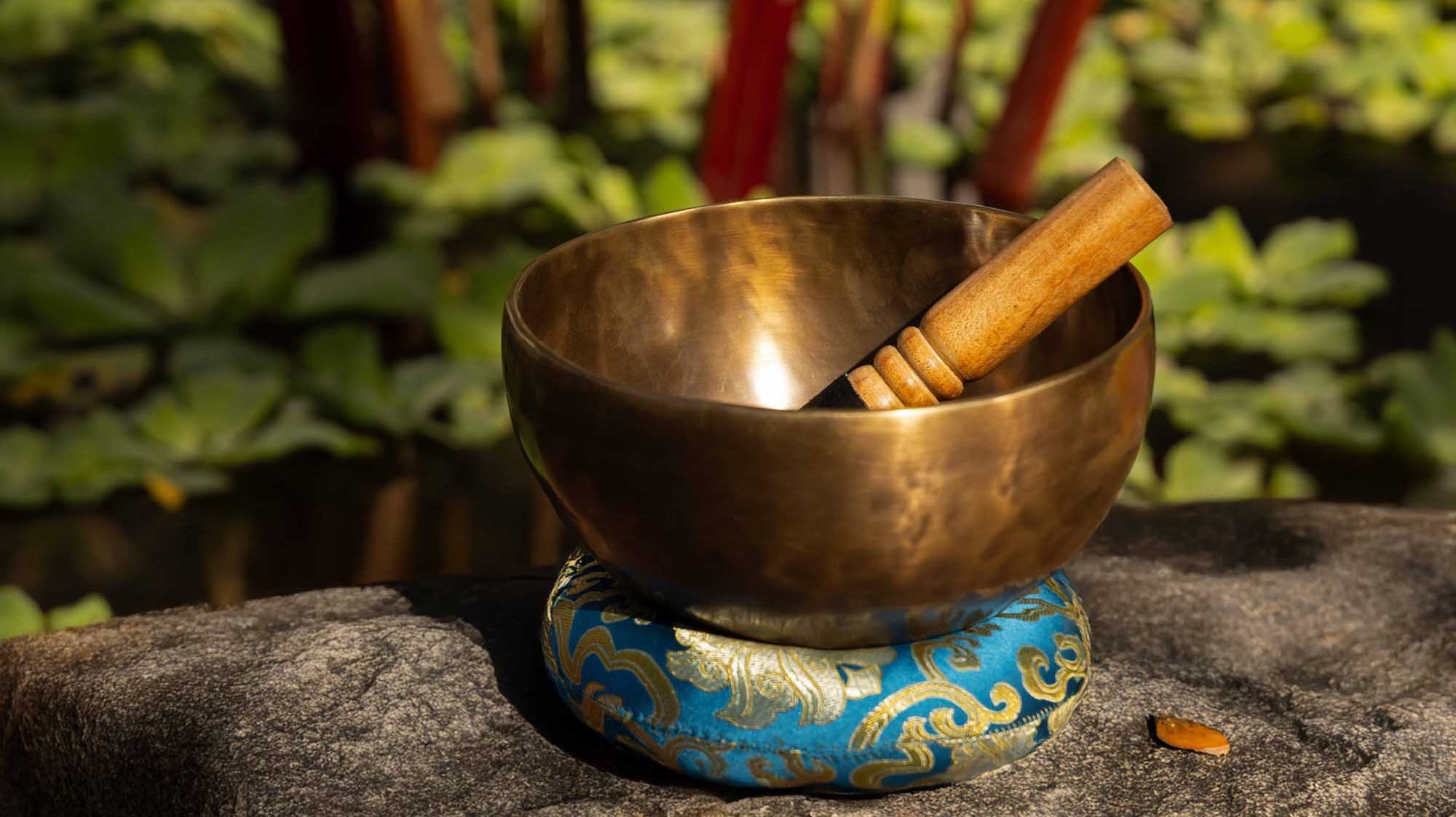 Medium bronze Tibetan singing bowl with mallet and cushion, illustrating the best first singing bowl for beginners.