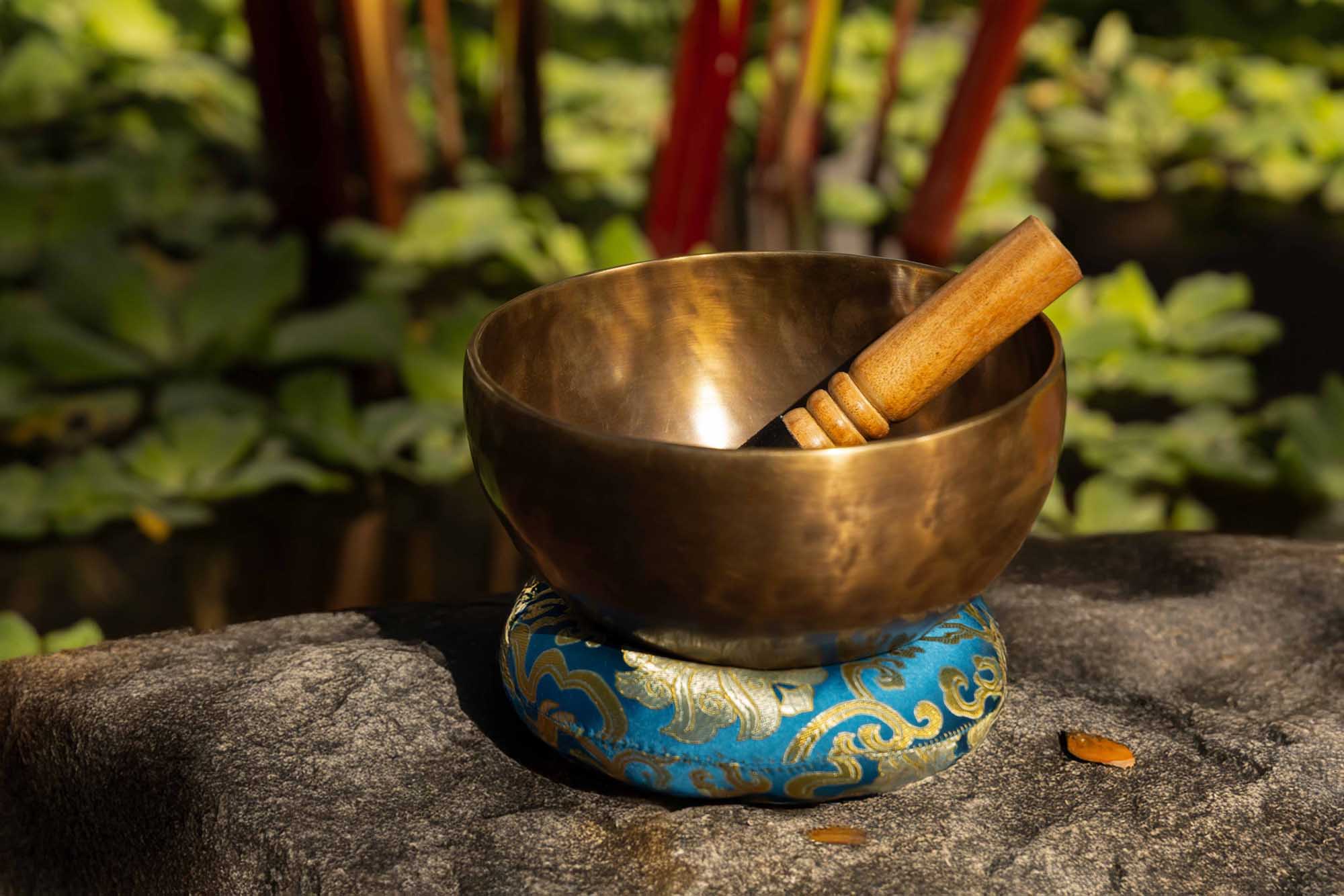 Medium bronze Tibetan singing bowl with mallet and cushion, illustrating the best first singing bowl for beginners.